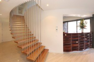 a room with a staircase and a plant in it