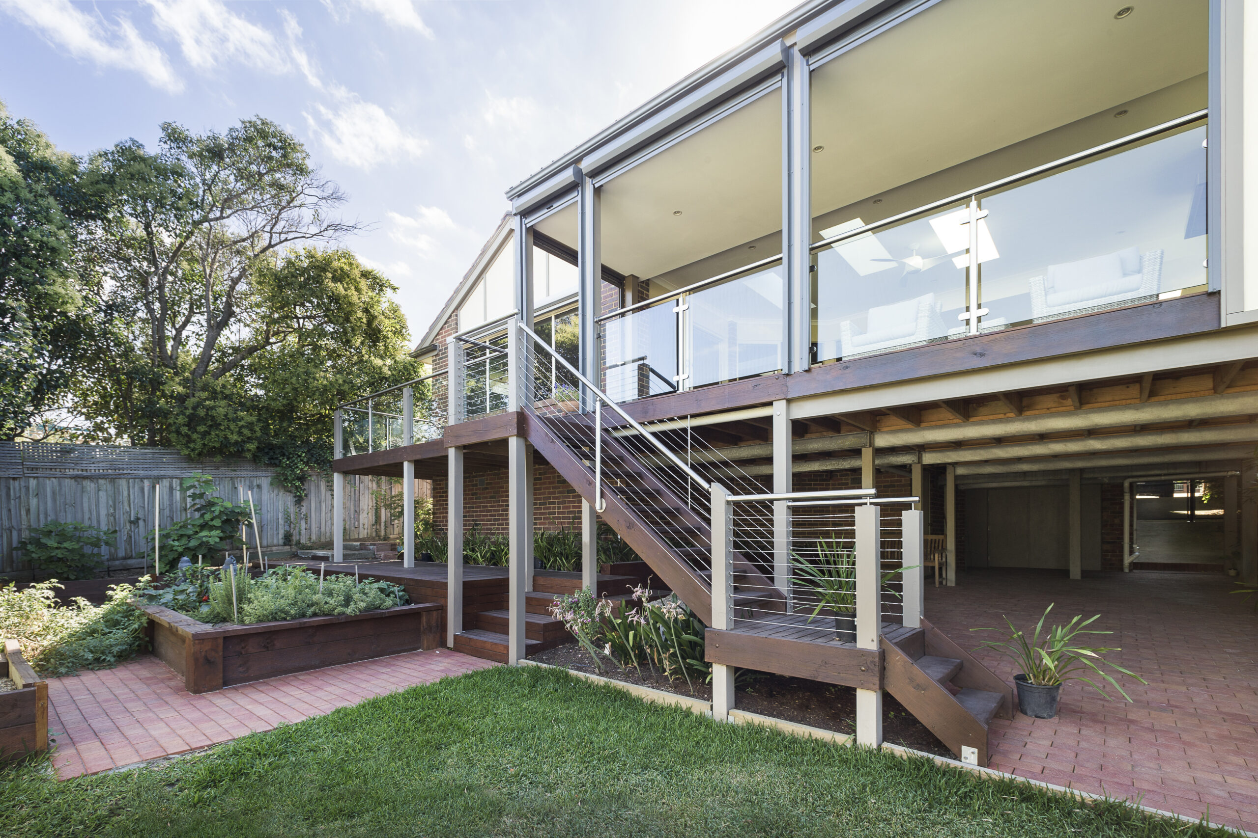 a house with a deck and a grass yard