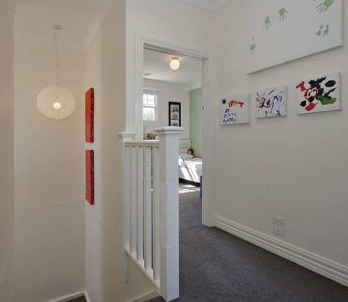 a hallway with a bed and a desk