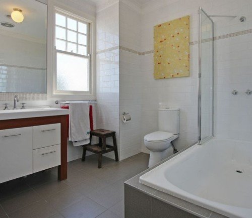 a bathroom with a tub toilet and sink