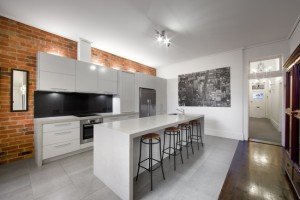 a kitchen with a brick wall