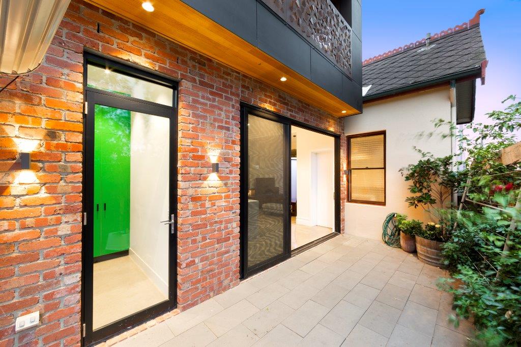 a brick building with a glass door