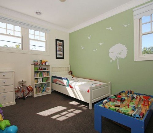 a room with a bed and a shelf with toys