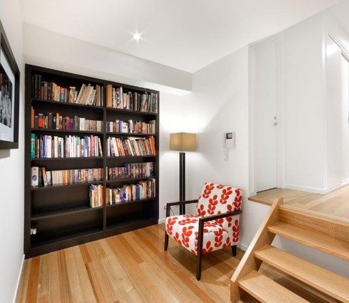 a room with a bookcase and a chair