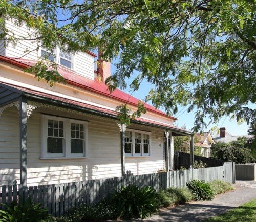 a house with a fence and trees