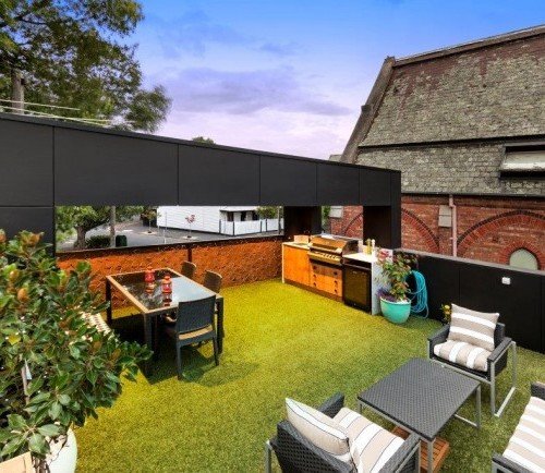 a backyard with a patio and a table and chairs