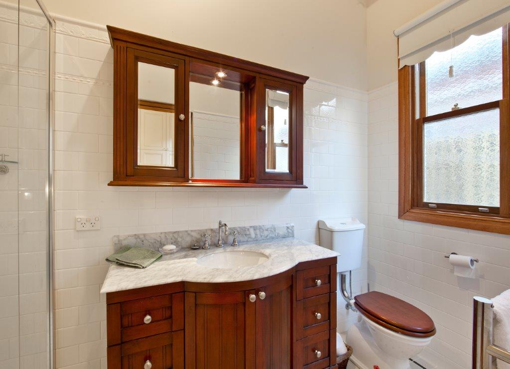 a bathroom with a sink toilet and mirror