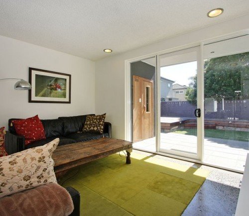 a living room with a large glass door