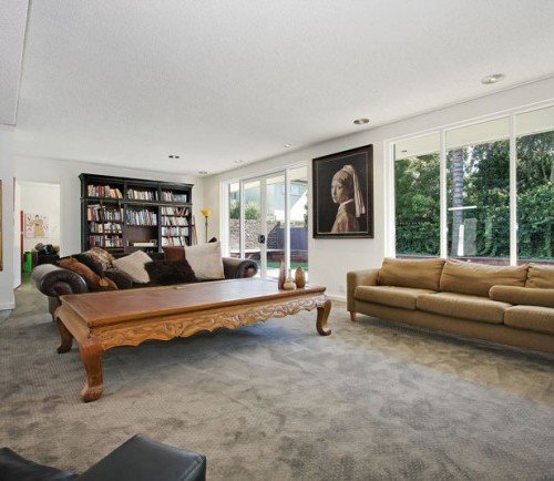 a living room with a couch and a book shelf