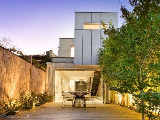 a house with a fence and a table in the front