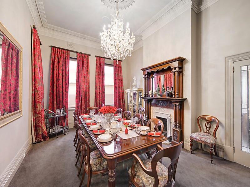 a dining room table with a chandelier above it