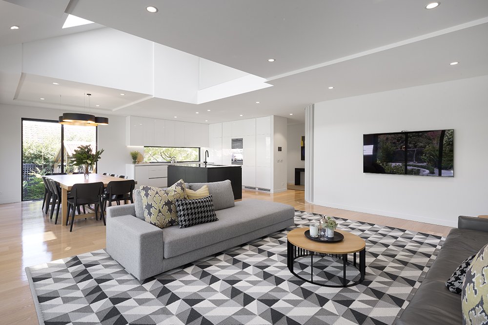 Open living area with grey sofas and a patterned rug
