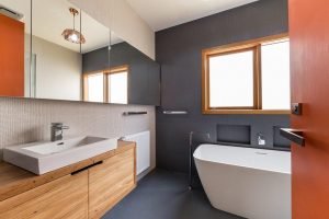 a bathroom with a tub sink and mirror