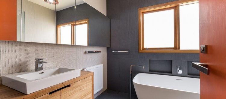 a bathroom with a tub sink and mirror