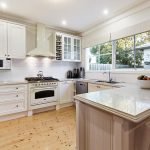 a kitchen with white cabinets