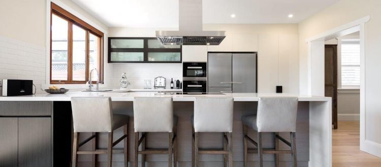 a kitchen with a bar stools