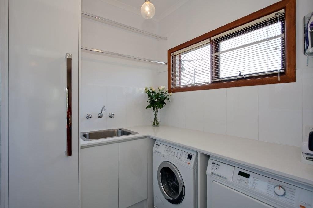 a sink and washing machine in a room