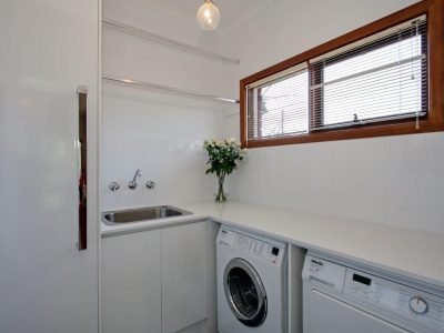 a sink and washing machine in a room