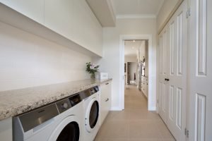 a room with a washing machine and a counter