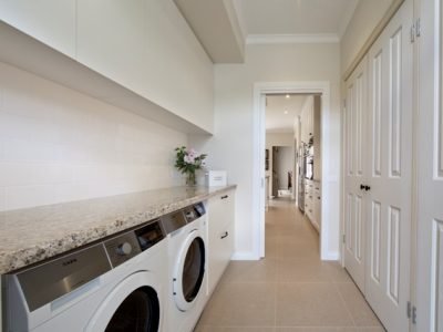 a room with a washing machine and a counter