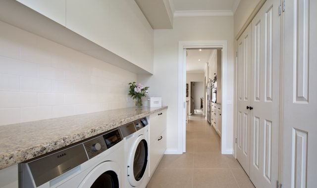 a room with a washing machine and a counter