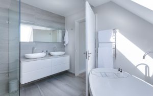 a bathroom with a tub sink and mirrors