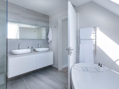 a bathroom with a tub sink and mirrors