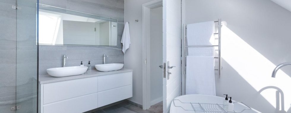 a bathroom with a tub sink and mirrors