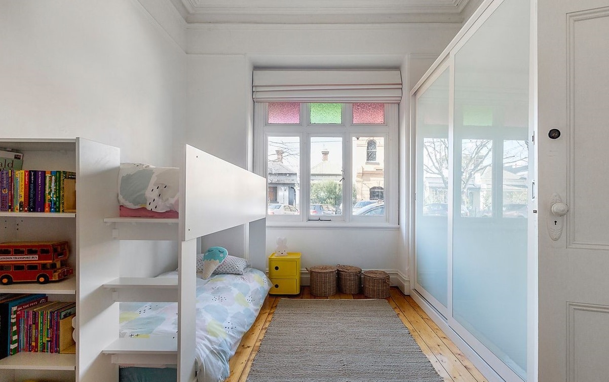 a bedroom with a bed and bookshelves