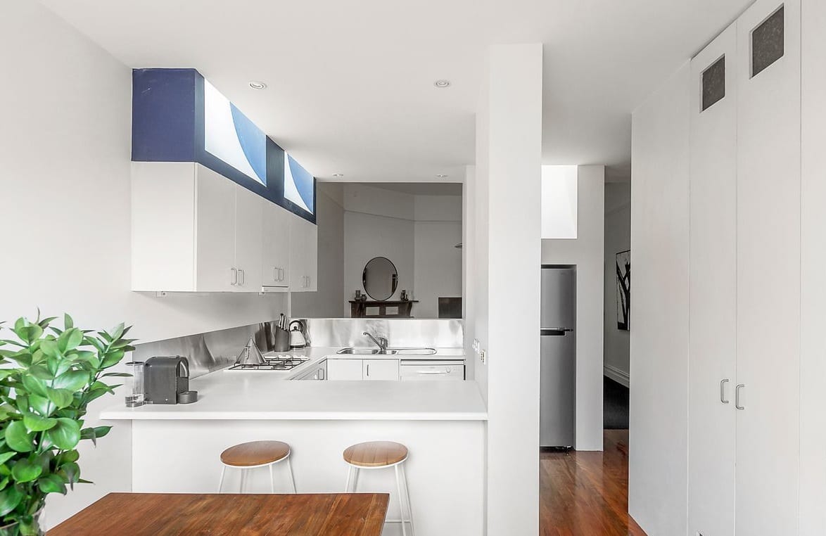 a kitchen with white cabinets