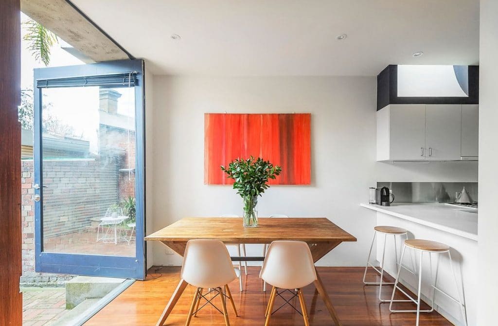 a kitchen with a table and chairs