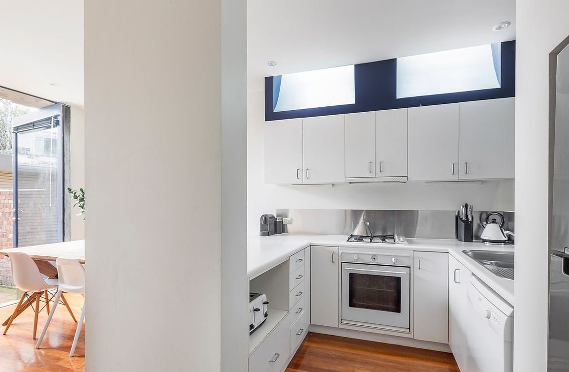 a kitchen with white cabinets