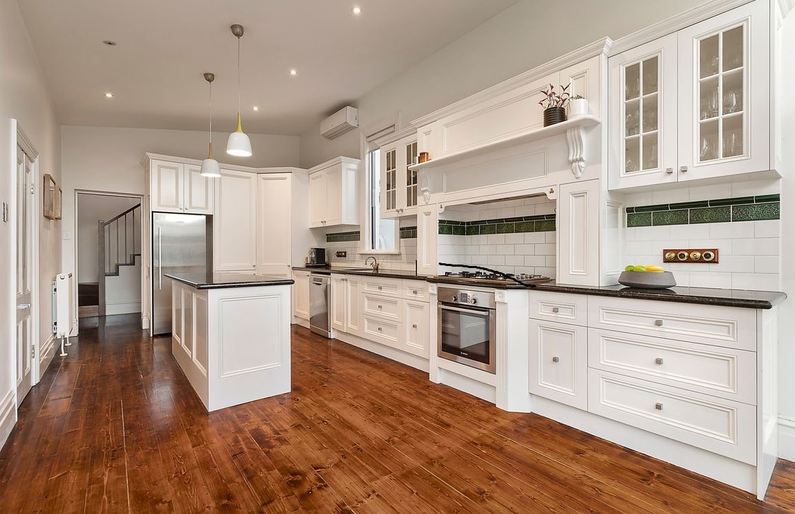 a kitchen with white cabinets