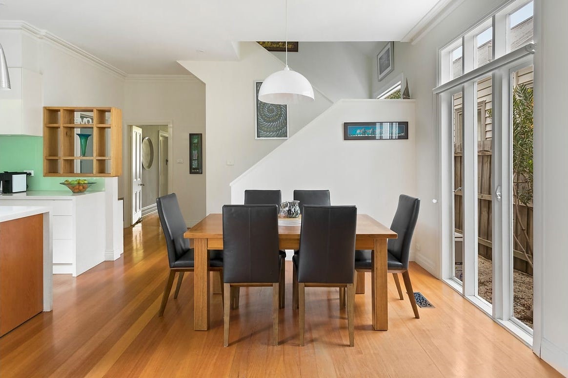 a dining room with a table and chairs