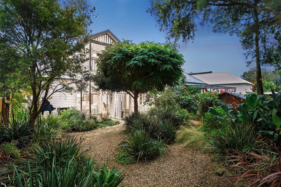 a house with trees and bushes