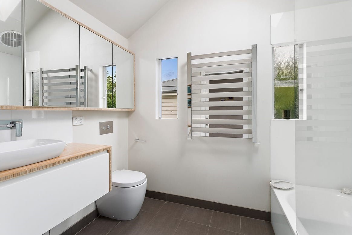 a bathroom with a tub sink and toilet