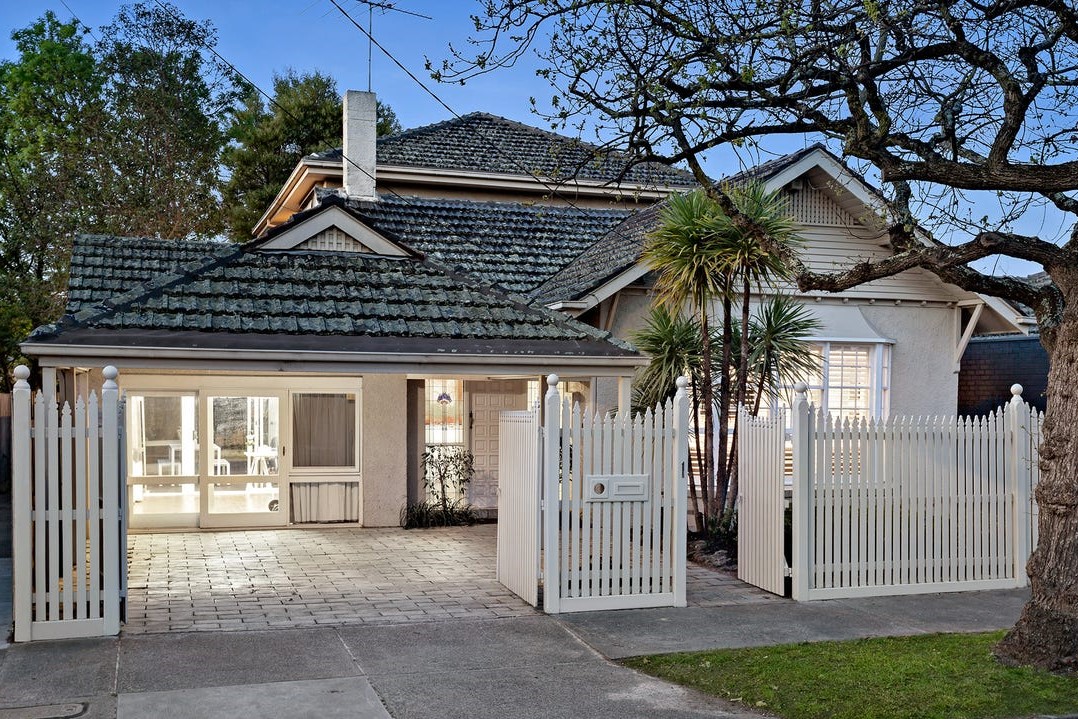 a house with a white fence