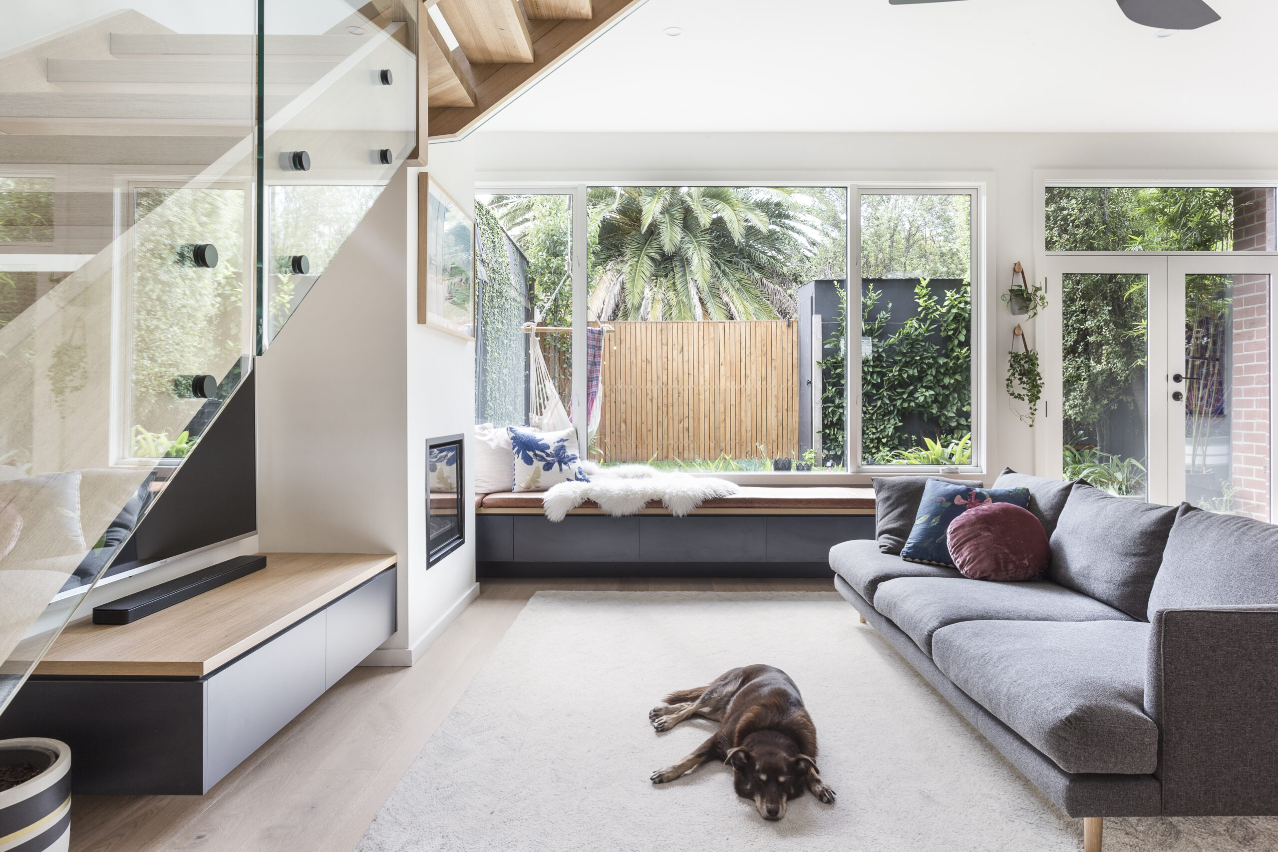 a living room with a couch and a piano