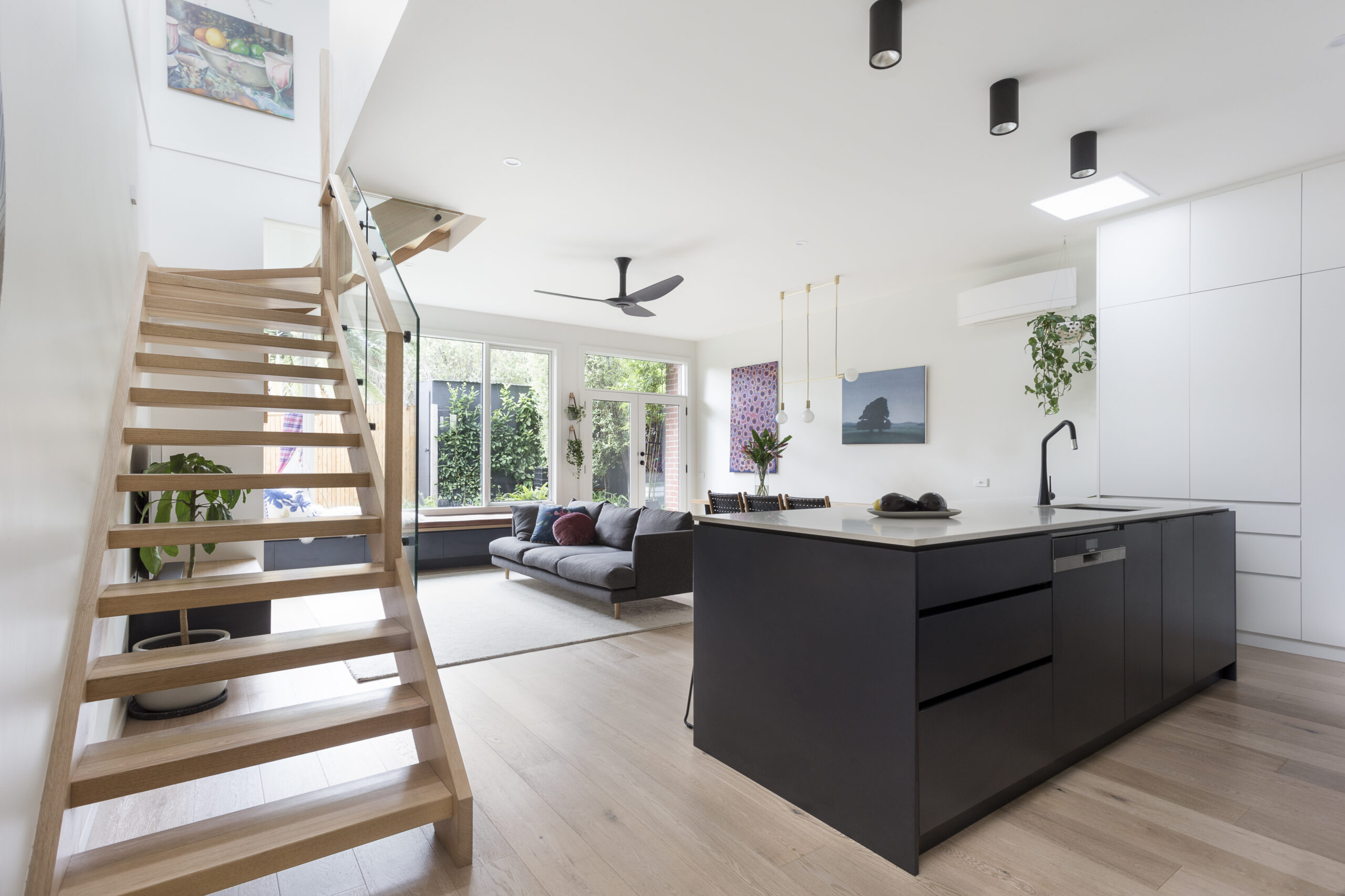 a kitchen with a wood staircase