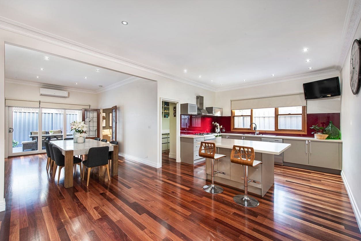 a large kitchen with a wood floor