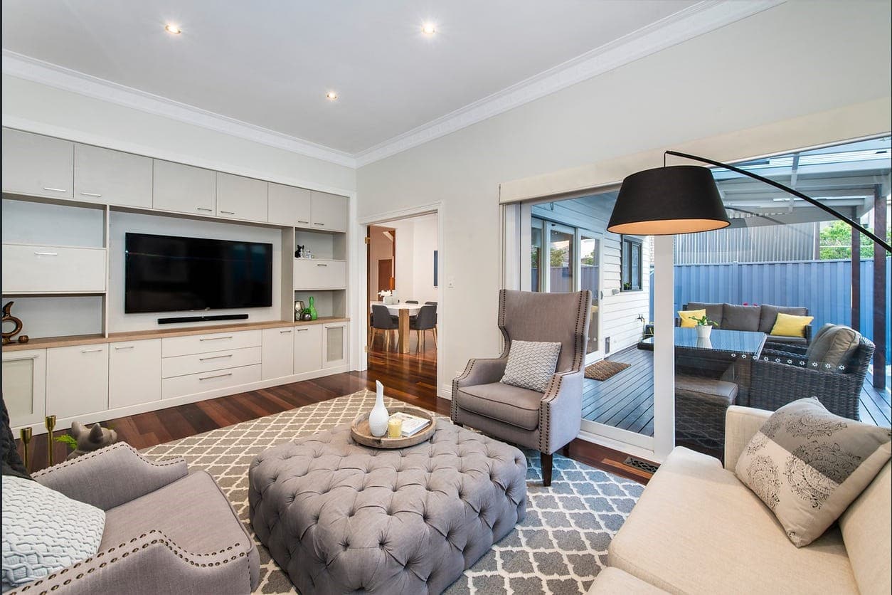 a living room with a tv and couches