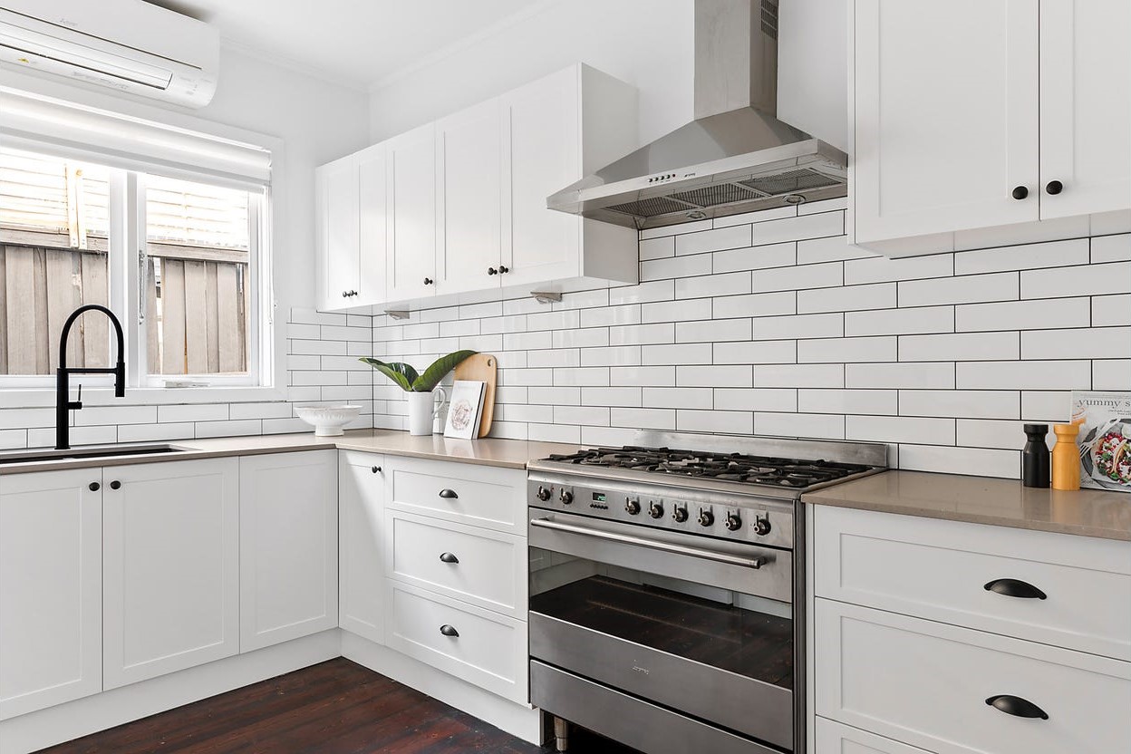 a kitchen with white cabinets