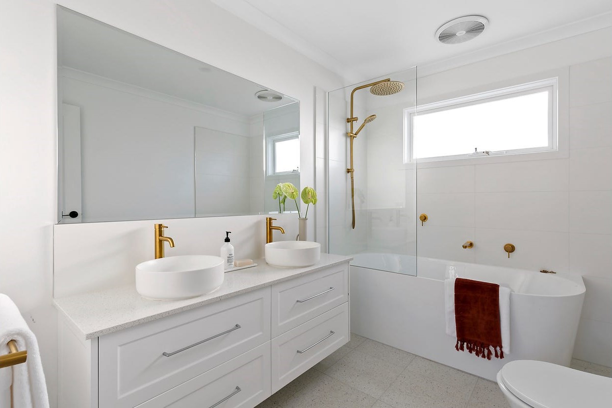 a bathroom with a tub sink and a mirror