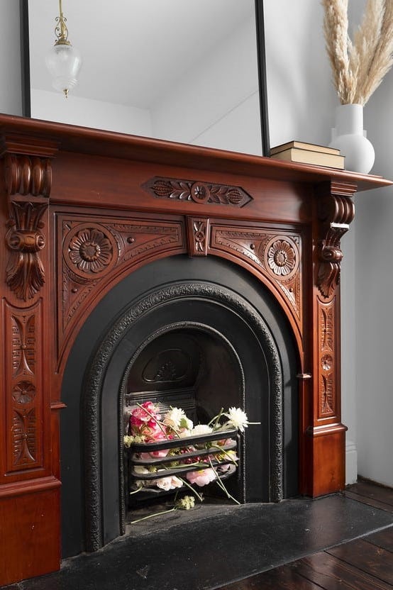 a fireplace with flowers