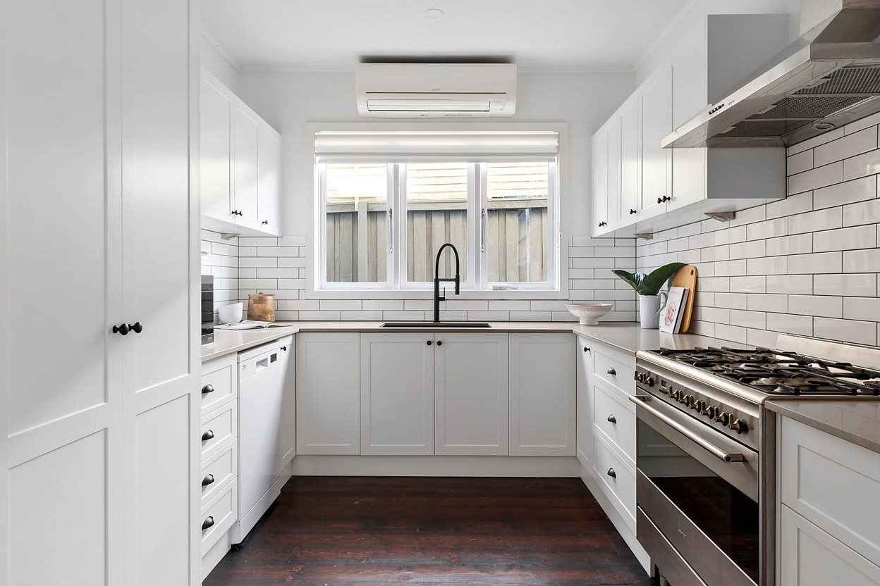 a kitchen with white cabinets