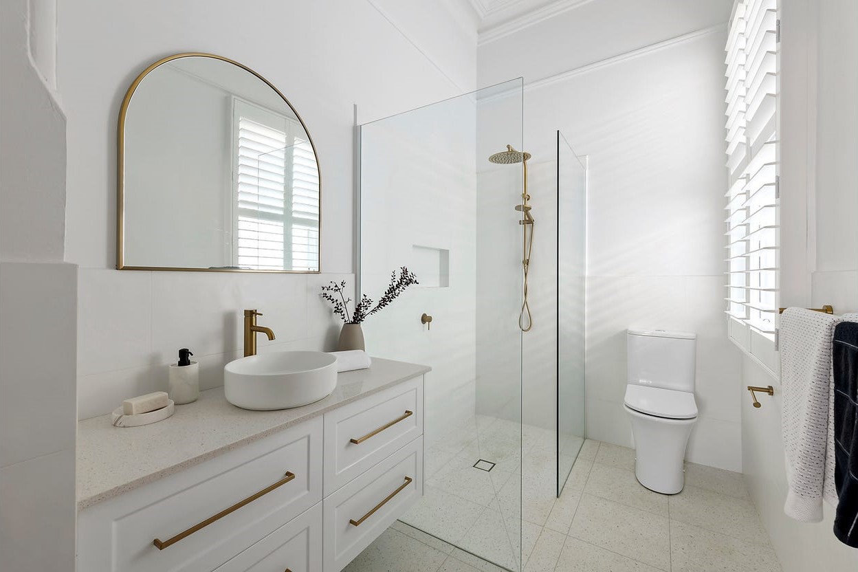 a bathroom with a sink toilet and mirror