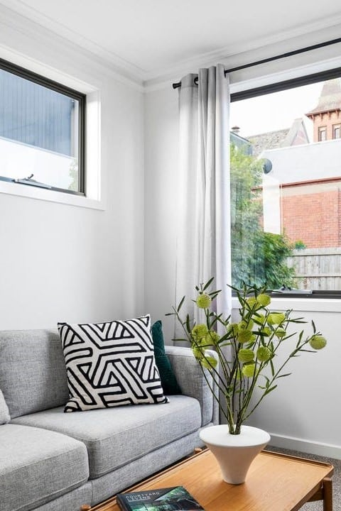 a couch and a table in a room with a window