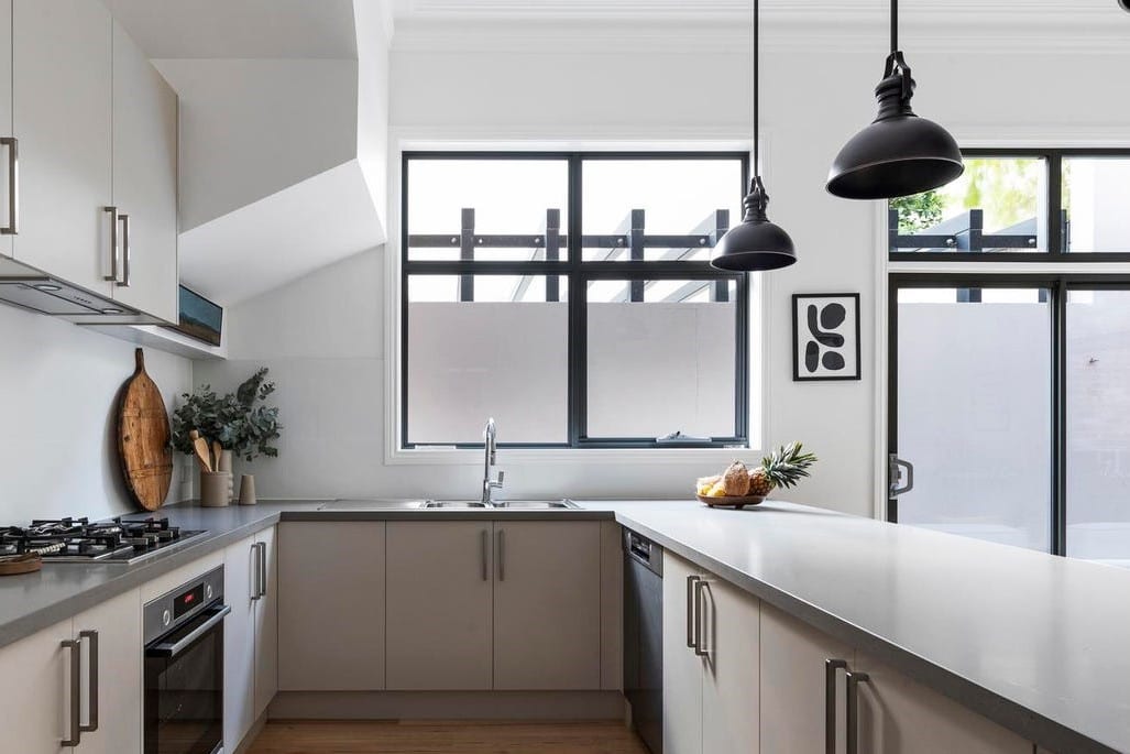 a kitchen with a stove and a window