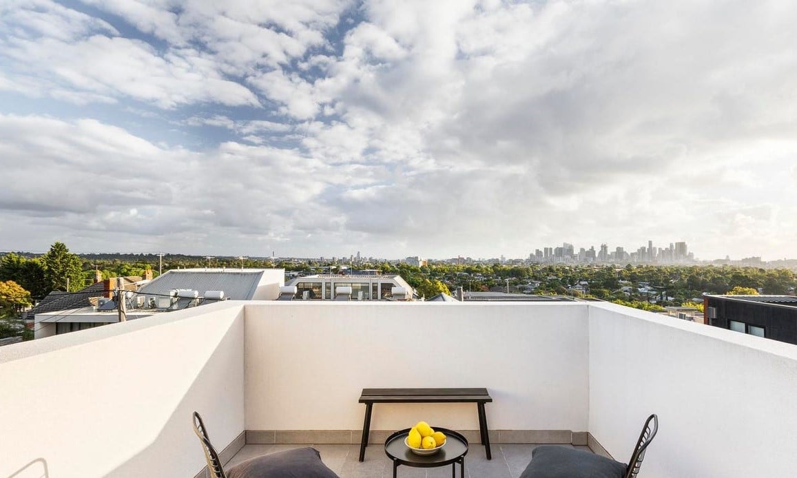 a rooftop with a fire pit and a view of a city