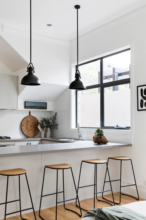 a kitchen with a counter top and stools